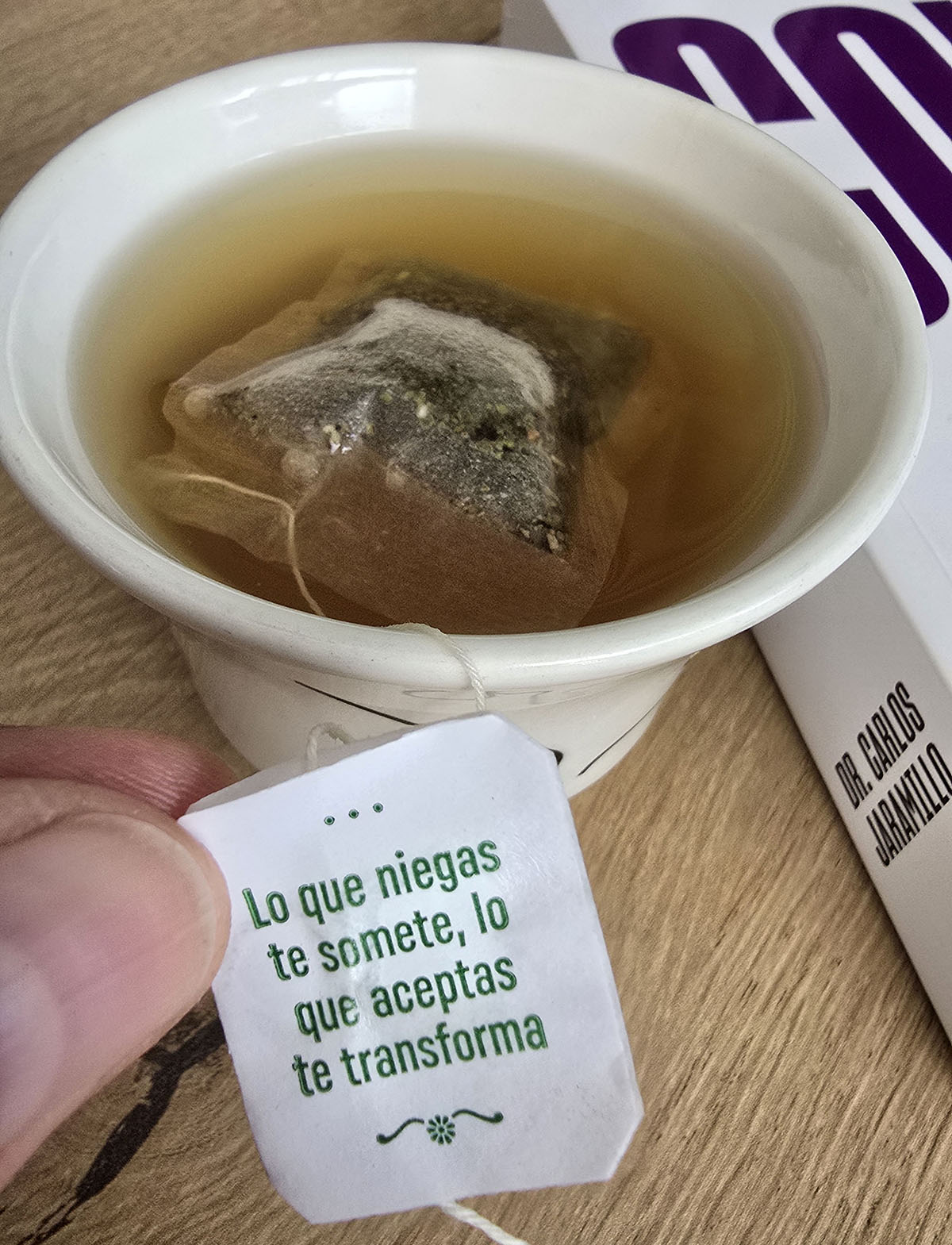 Teacup with tag and a calm, reflective scene